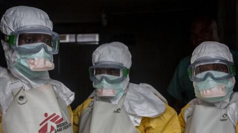 Medical staff dressed in protective gear before entering an isolation area at an Ebola treatment centre in Goma.