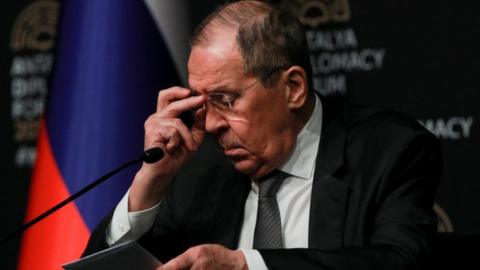 Russian Foreign Minister Sergei Lavrov looks down at his notes during a press conference.