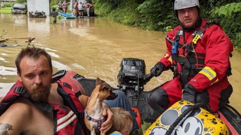 A rescue team evacuates residents from their homes through flooded streets, in Breathitt County, Kentucky