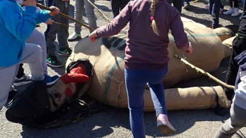 Children beating Judas effigy in Pruchnik, 19 Apr 19