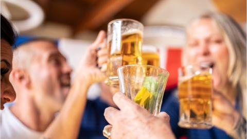 People clink glasses during a celebration