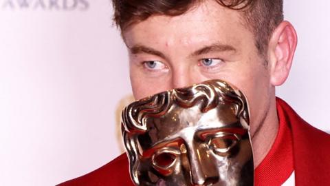 Barry Keoghan poses with his award for best actor in a supporting role