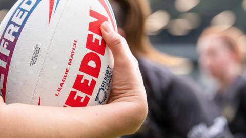 Rugby league ball being held