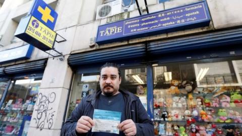 A man shows the marijuana he has bought in a pharmacy in Uruguay