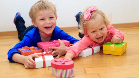 A brother and sister with presents