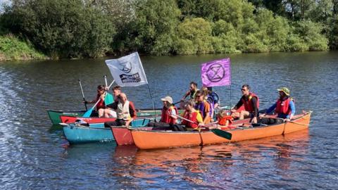 Extinction Rebellion activists in a boat