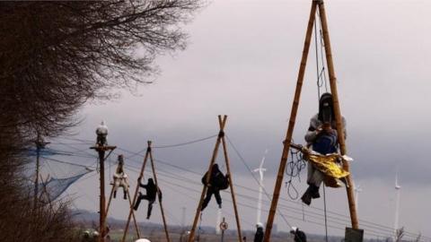 Police keep guard as activists stage a sit-in protest against the expansion of the Garzweiler open-cast lignite mine of Germany's utility RWE, in Luetzerath, Germany, January 11, 2023