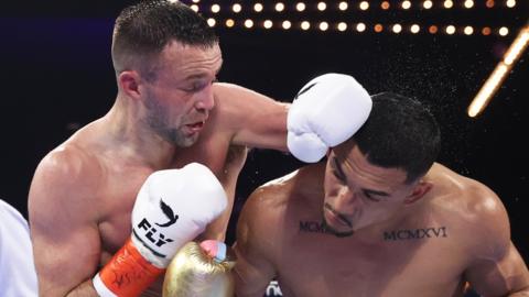 Josh Taylor punches Teofimo Lopez