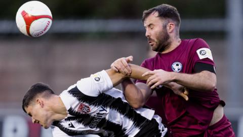 Flint Town's Harry Owen and Steve Tomassen of Airbus in action