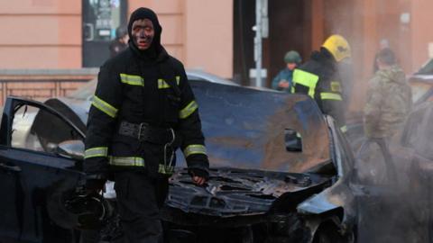 A firefighter takes a pause as he works to extinguish burning cars following what Russian authorities say was a Ukrainian military strike in Belgorod, Russia December 30, 2023