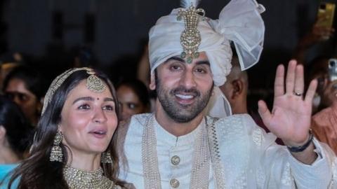 Bollywood actors Rabir Kapoor (R) and Alia Bhatt (L) pose for photos after their wedding at their residence in Mumbai, India, 14 April 2022.