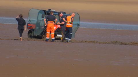 Buggy trapped in mud on beach