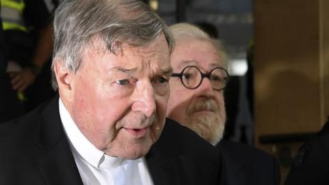 Cardinal George Pell and his lawyer Robert Richter leaving a Melbourne court