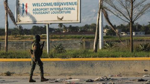 A Haitian soldier patrols outside the Toussaint Louverture International Airport following a gunfight with armed gangs in the surroundings of the airport, as the government declared a state of emergency amid violence, in Port-au-Prince, Haiti, March 4, 2024.