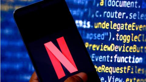 Netflix photo with computer coding in the background