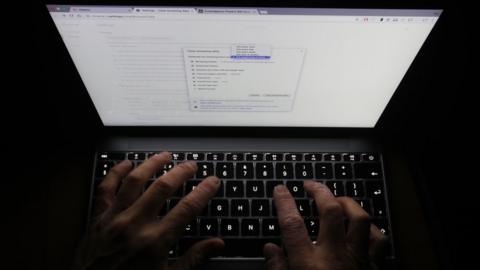 A man looks at the settings on his laptop's Chrome browser