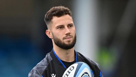 Max Green holds a rugby ball during training with Bath