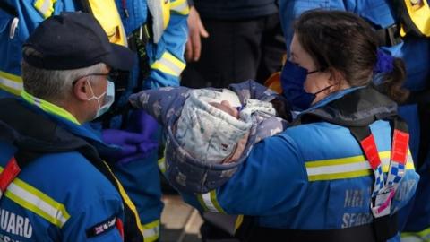 Baby being brought ashore