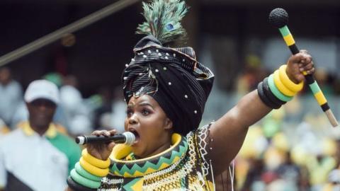 A praise singer takes to the stage to traditionally welcome African National Congress