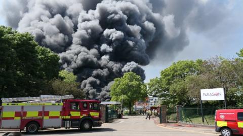 Smoke billows over the building