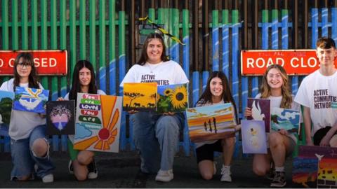 Young people in front of the 'peace gate'