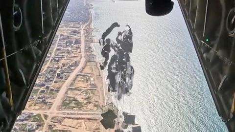 Aid parcels being dropped into Gaza from an aircraft