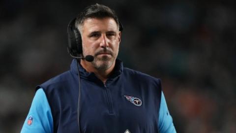Mike Vrabel on the touchline wearing a head mic