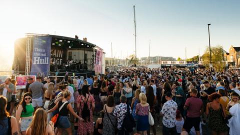 Hundreds of people in front of a music stage on Hull Marina
