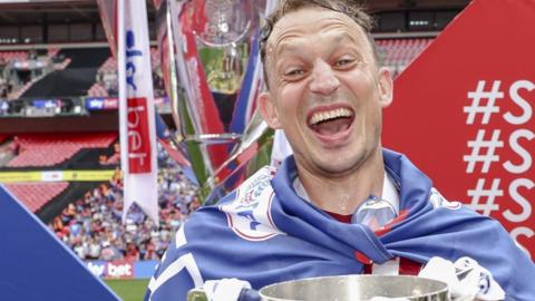 Kristian Dennis helped Carlisle United win promotion to League One through the play-offs in his final game for the club