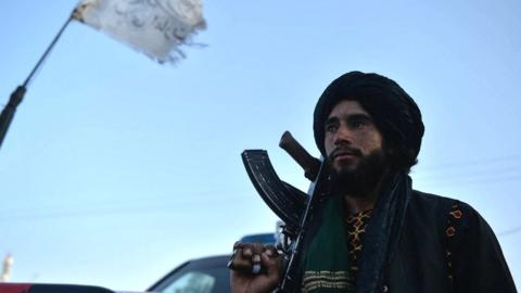 A Taliban fighter stands at a roadside in Herat, 19 September 2021