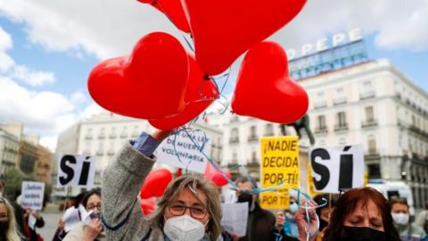 Supporters of a law to legalise euthanasia gather as the Spanish Parliament votes to approve it, in Madrid, Spain