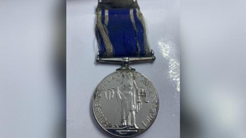 medal recovered from river