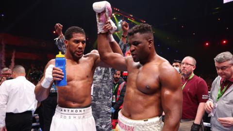 Anthony Joshua raises Francis Ngannou's hand