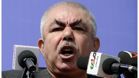 Abdul Rahid Dostum addresses a crowd in the outskirts of Kunduz province, north of Kabul, on March 19, 2014.