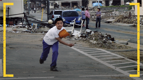 A young Japanese boy pitches a baseball in the aftermath of the Fukushima disaster