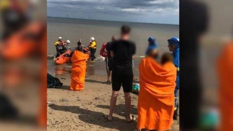 The RNLI crew rescuing the family in Withernsea