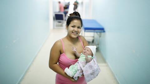 Lismaris, 21, who travelled from Monagas state, holds her three-day-old baby Cecilia.