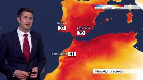 Chris Fawkes stands in front of a weather map showing record-breaking temperatures in Spain and north Africa