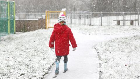 Child walking in the snow