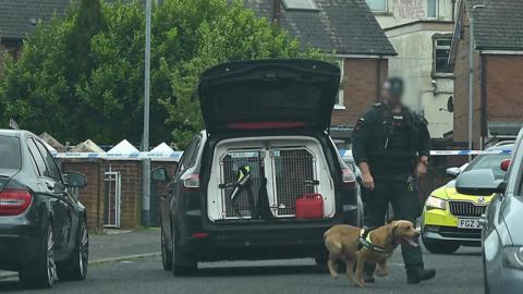 Police and police dog at security alert