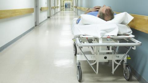 Patient waiting on a hospital trolley