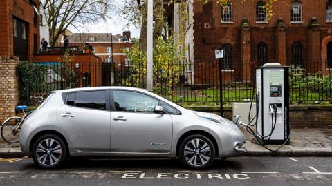 A Nissan LEAF charges on a street in Hackney