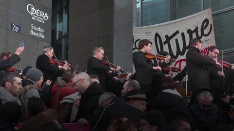 Musicians of the Paris opera orchestra stage an impromptu concert outside the Bastille opera