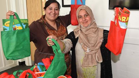 Charity workers pack gift bags for Eid