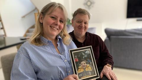 Andrew and Elena Round, with a picture of their son Billy