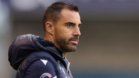 Reading boss Ruben Selles wearing a puffer coat watches his side take-on Millwall in the first round of the EFL Cup