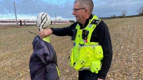 Scarecrow with one of the officers who responded