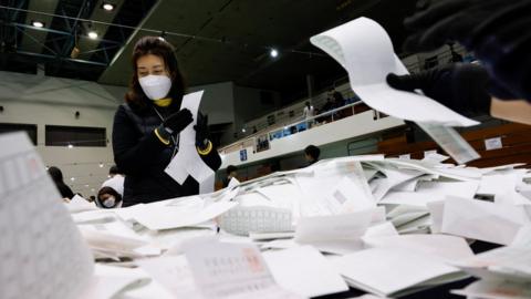 National Election Commission officials count ballots during the 22nd parliamentary election in Seoul, South Korea