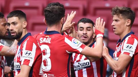 Atletico Madrid's players celebrate scoring against Huesca