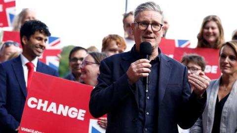 Labour Party leader Sir Keir Starmer speaks to supporters via a microphone during a general election campaign event before being elected prime minster